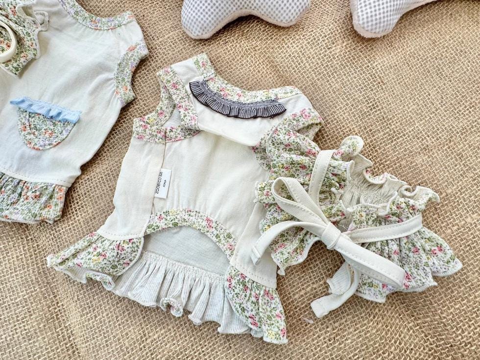 Floral ruffle dress set for pets featuring a cream sleeveless top and matching floral skirt.