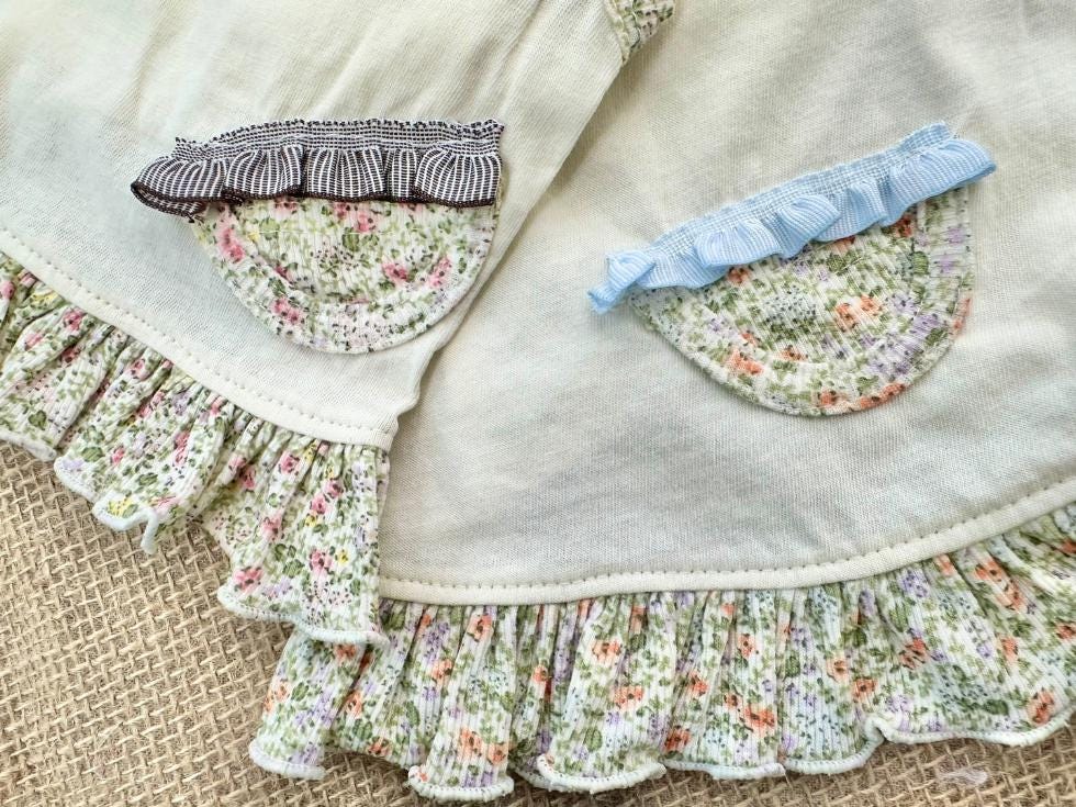 Floral ruffle pet dress set in cream and pastel floral print with ruffle details.