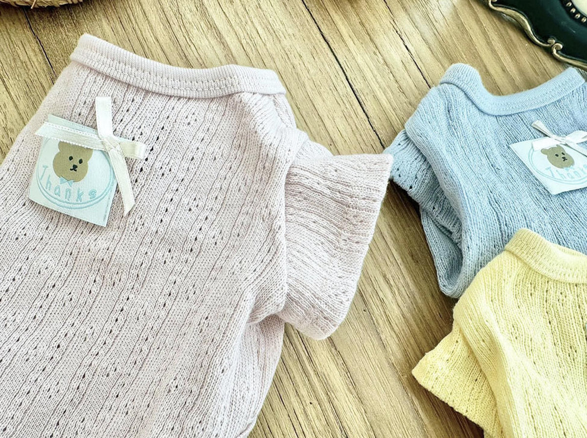 Vicky Eyelet Dog Cardigan in light pink, blue, and yellow knit textures