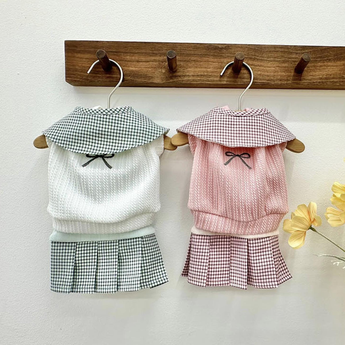Two NKpup gingham collar pleated dresses for pets, one in white and one in pink.