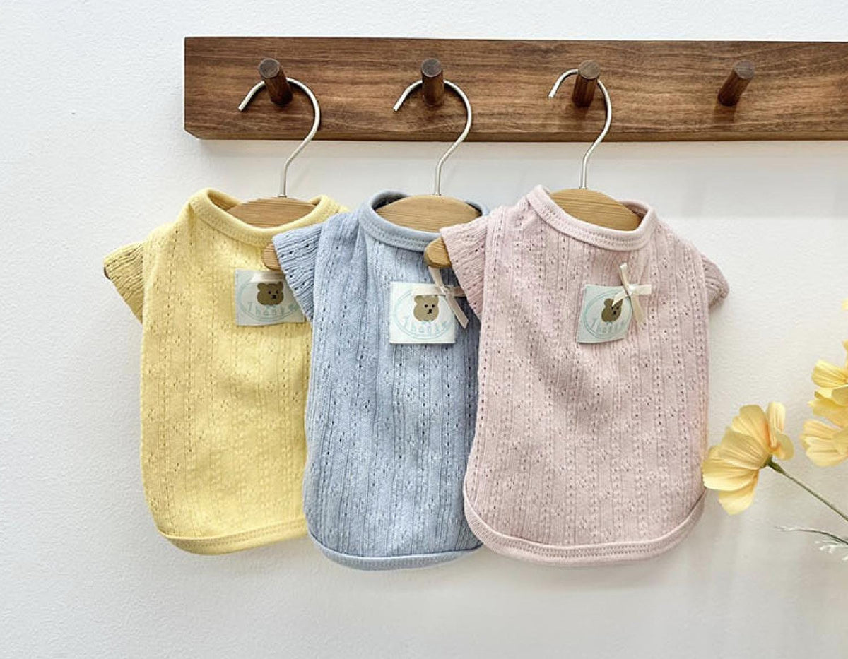 Vicky Eyelet Dog Cardigan in yellow, light blue, and pink colors.