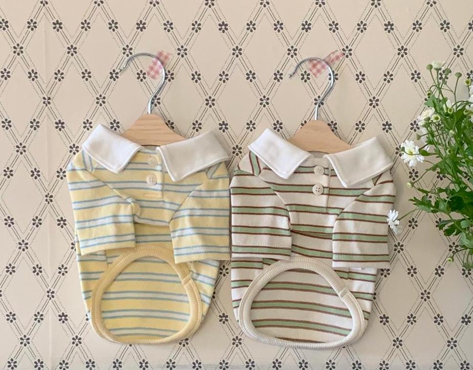 Two NKpup striped dog polo shirts with white collars in yellow and beige colors.