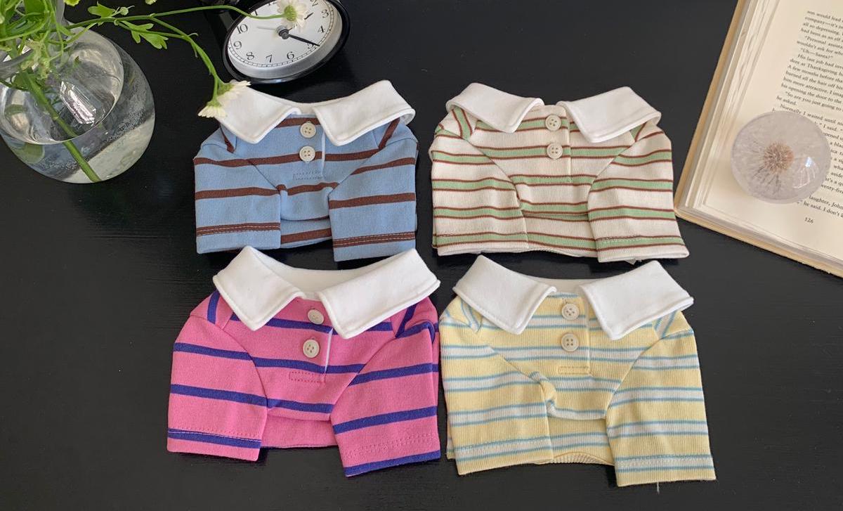 NKpup striped dog polo shirts in blue, cream, pink, and yellow with white collars.