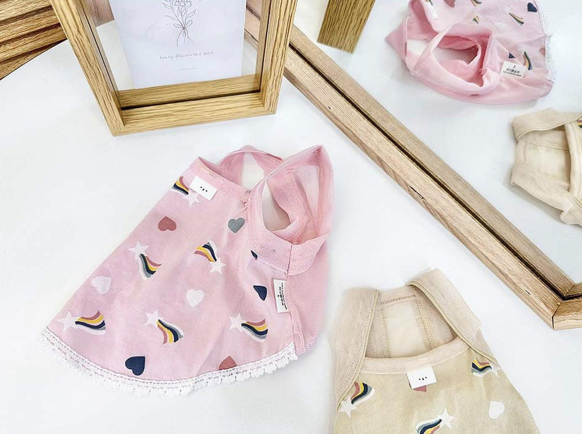 Pink rainbow print dog dress with heart patterns and white lace trim