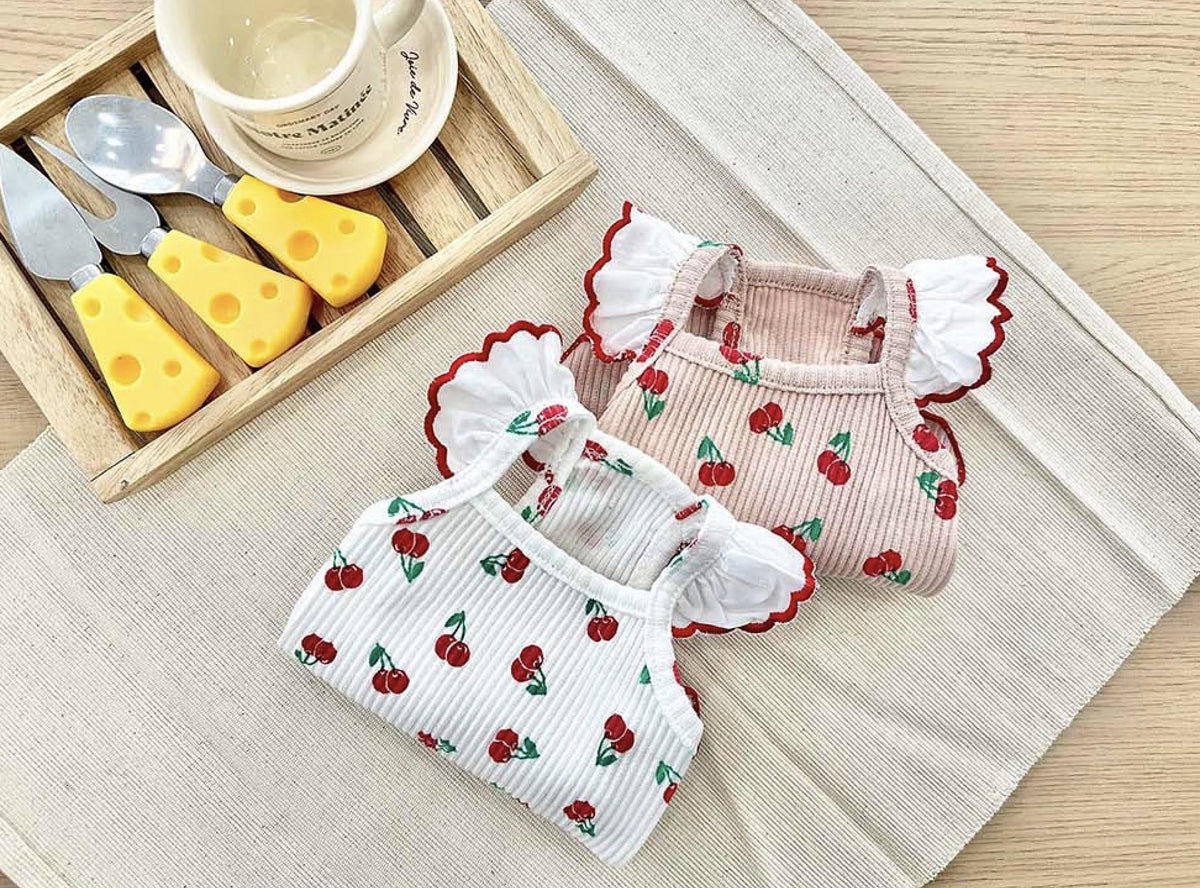NKpup Cherry Frill Ribbed Tops for dogs in white and pink with cherry patterns and ruffled sleeves.