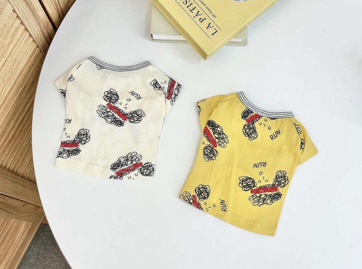 NKpup Run Sketch Tee dog shirts in cream and yellow with playful cartoon sketches