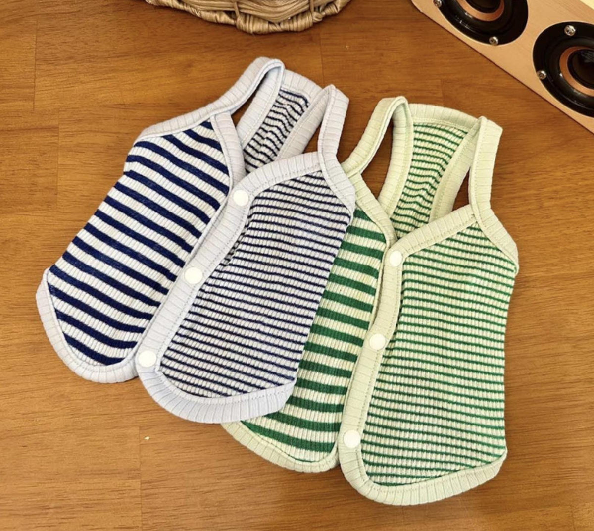 Three striped ribbed dog vests in blue, light blue, and green colors.