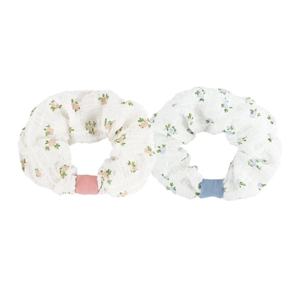 Two floral print scrunchies in white with pink and blue accents.