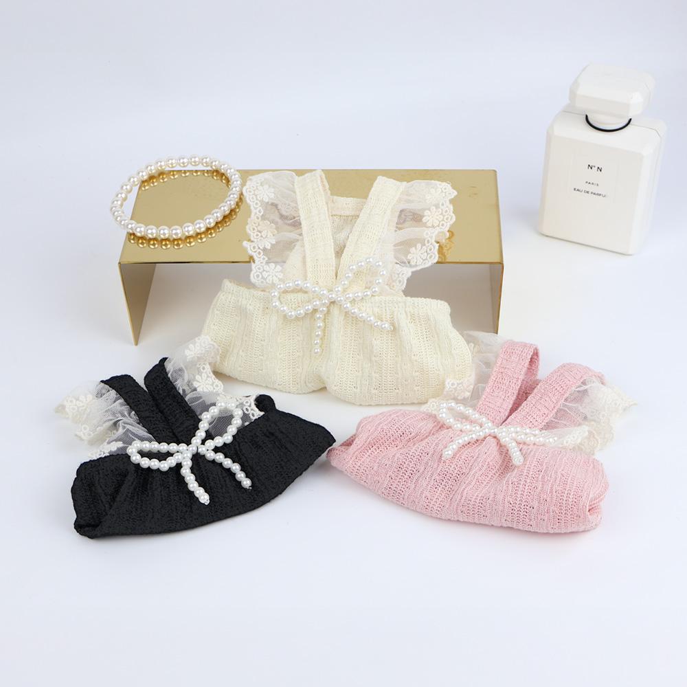 NKpup Pearl Ruffle Tops for dogs in cream, pink, and black with pearl bow details.