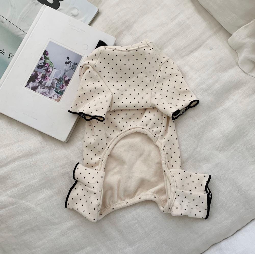 Cream dog romper with black polka dot pattern