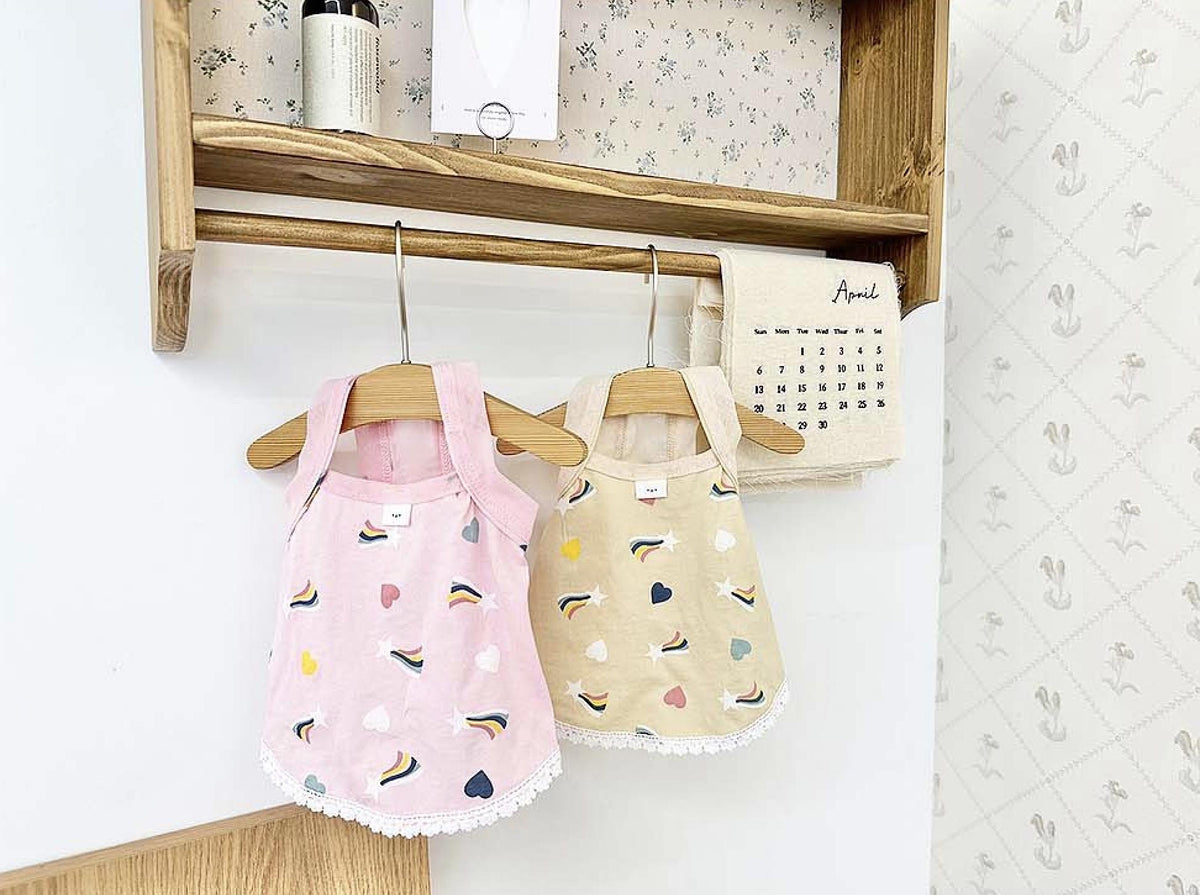 NKpup rainbow print dog dresses in pink and beige with heart and star patterns.