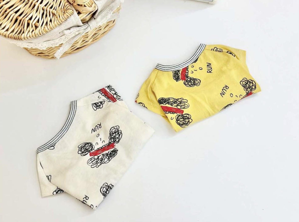 Two NKpup Run Sketch Tee dog shirts, one white and one yellow, featuring a black sketch pattern.