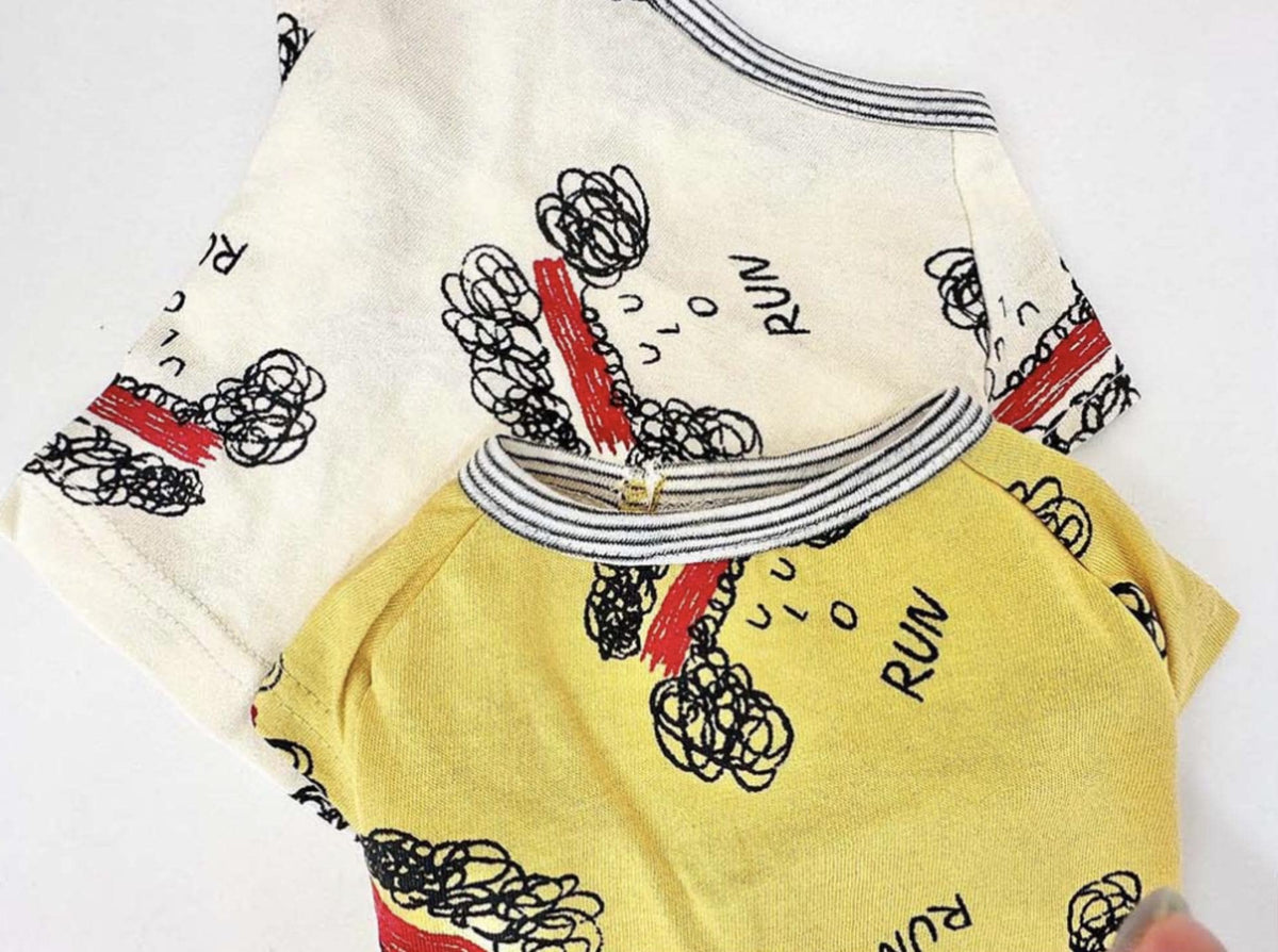 Run Sketch Tee pet shirt in cream and yellow with black sketches and red stripes.