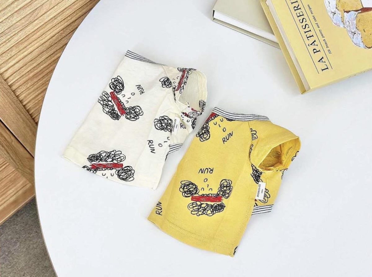 NKpup Run Sketch Tee dog shirts in cream and yellow with black sketch patterns.