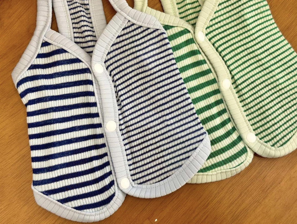 Three striped ribbed dog vests in blue and green colors with snap button closures.