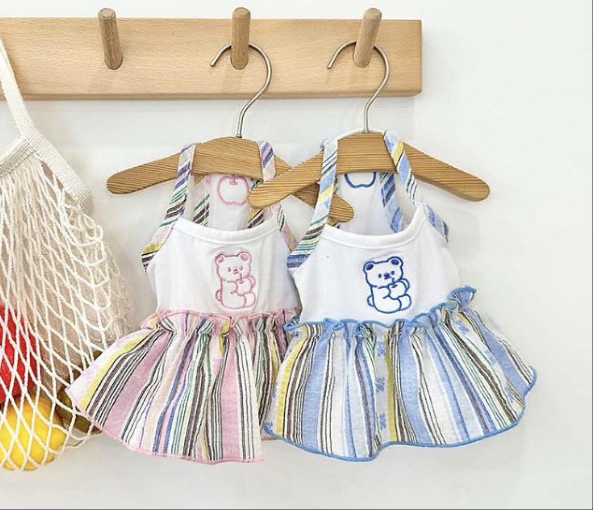 Two NKpup striped bear dresses for pets, one in pink and one in blue.