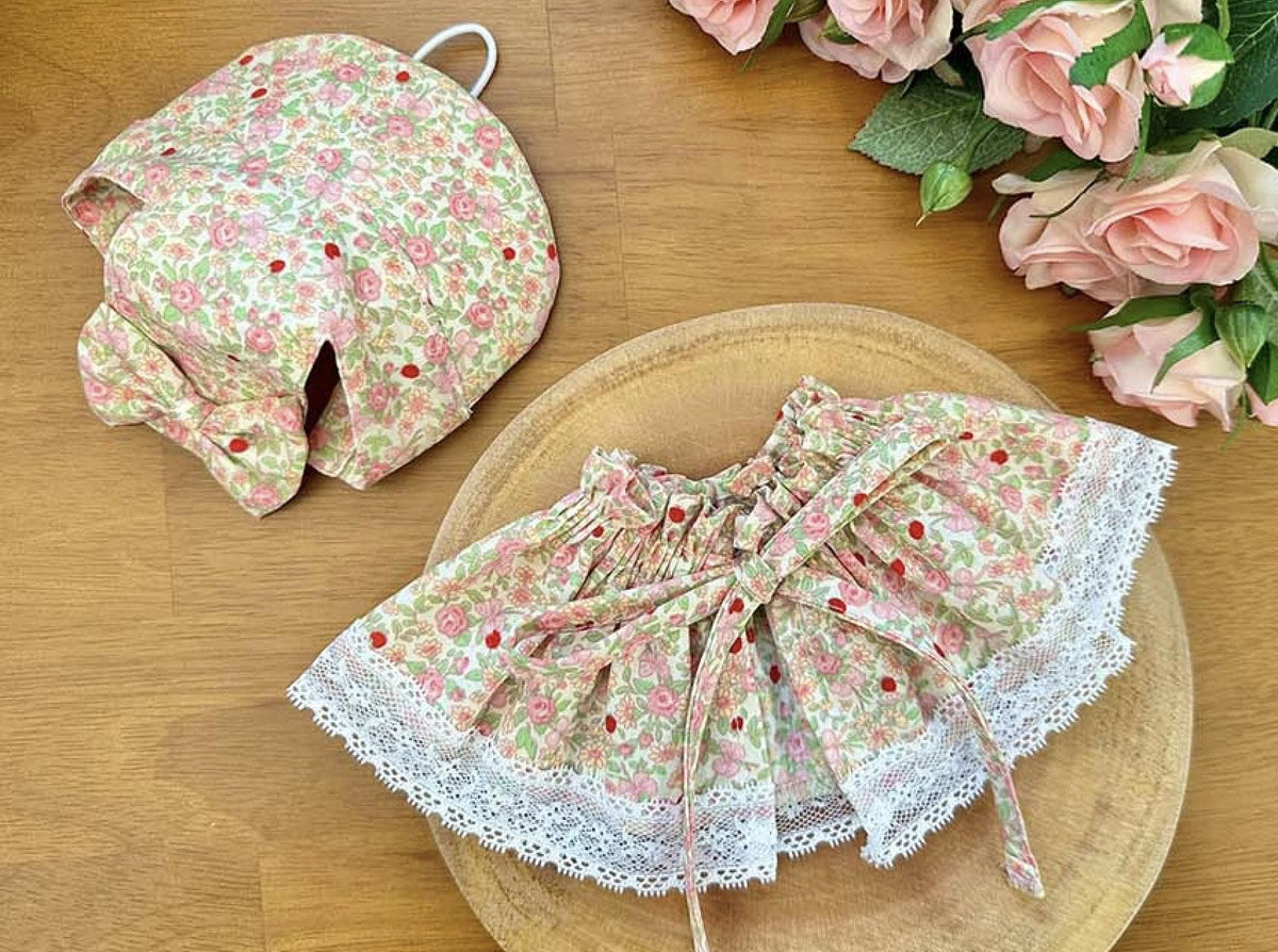 Floral pattern pet cape and matching bonnet with white lace trim by NKpup.
