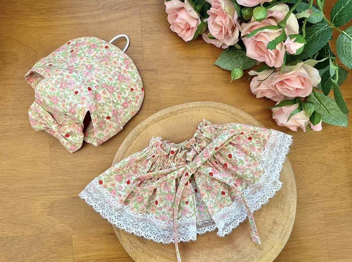 Floral pattern pet cape and matching bonnet with white lace trim by NKpup.