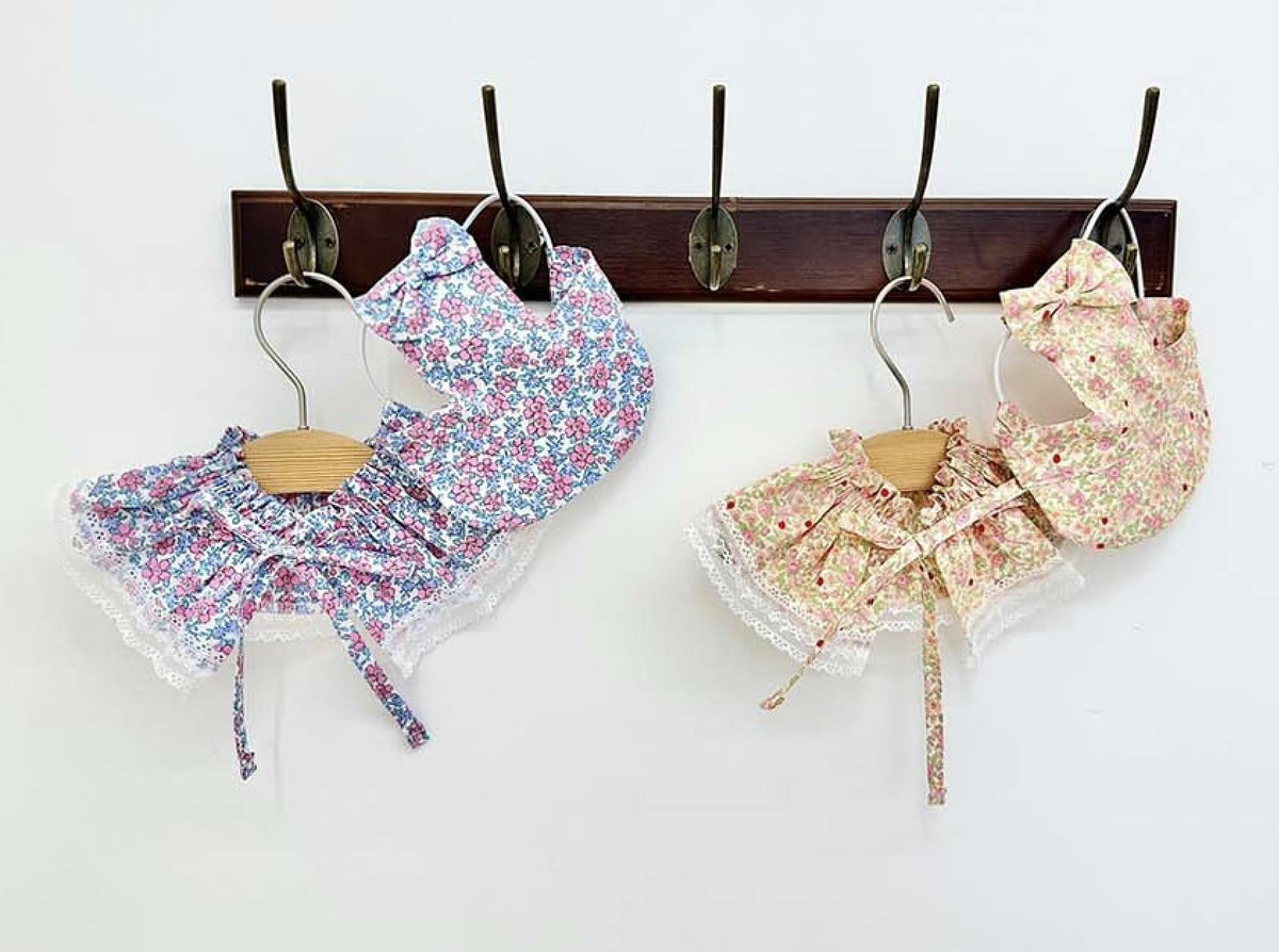 Two sets of NKpup floral pet capes and bonnets in blue and pink patterns with lace trim.