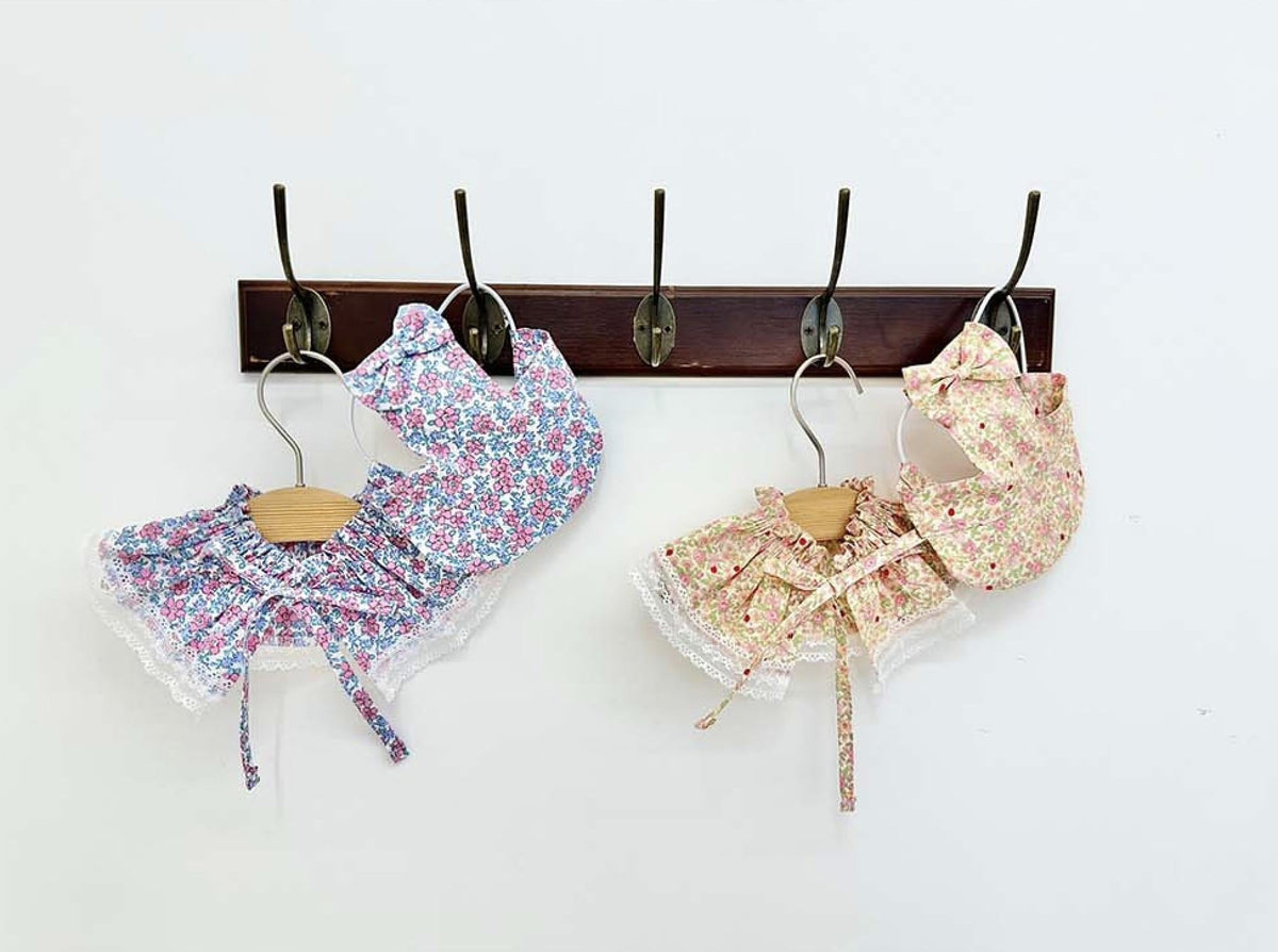 Two sets of NKpup floral pet capes and bonnets in blue and pink patterns with lace trim.