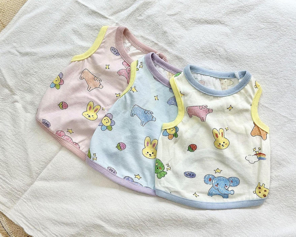 ZOO Friends dog shirts in pastel pink, blue, and cream with animal and flower prints.