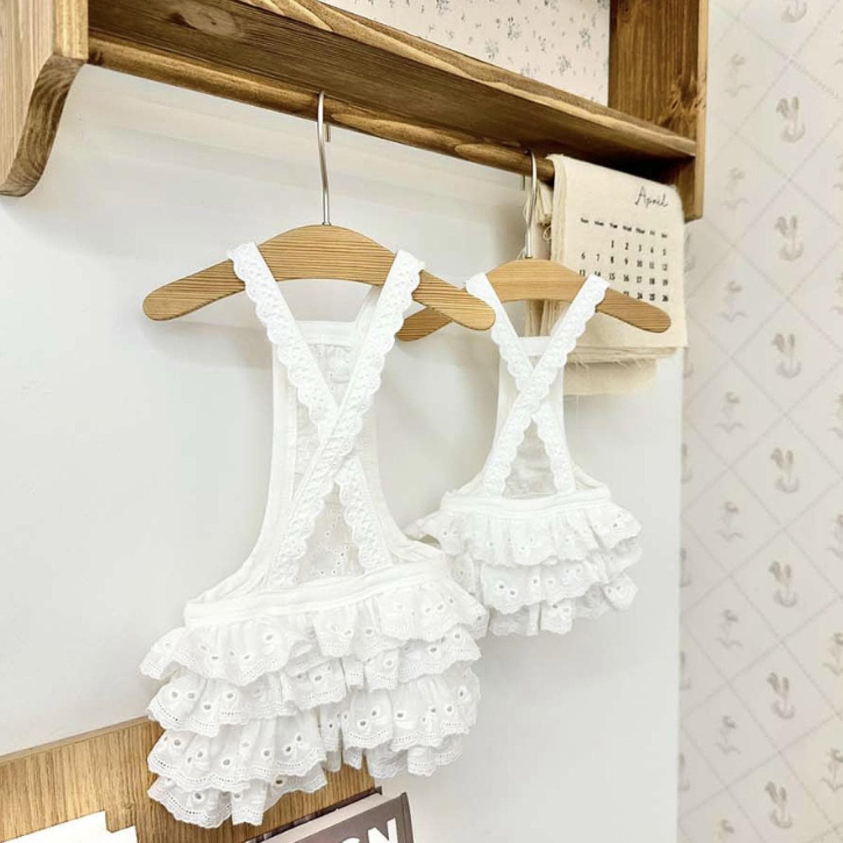 White eyelet lace romper dress for pets with criss-cross straps and ruffled hem