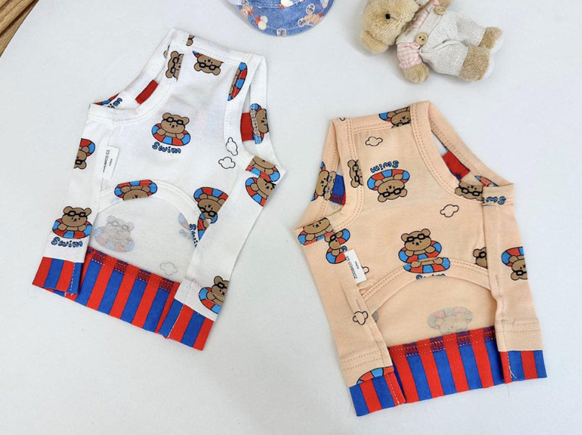 NKpup Teddy Float Top dog vests in white and beige with teddy bear prints and red and blue stripes.