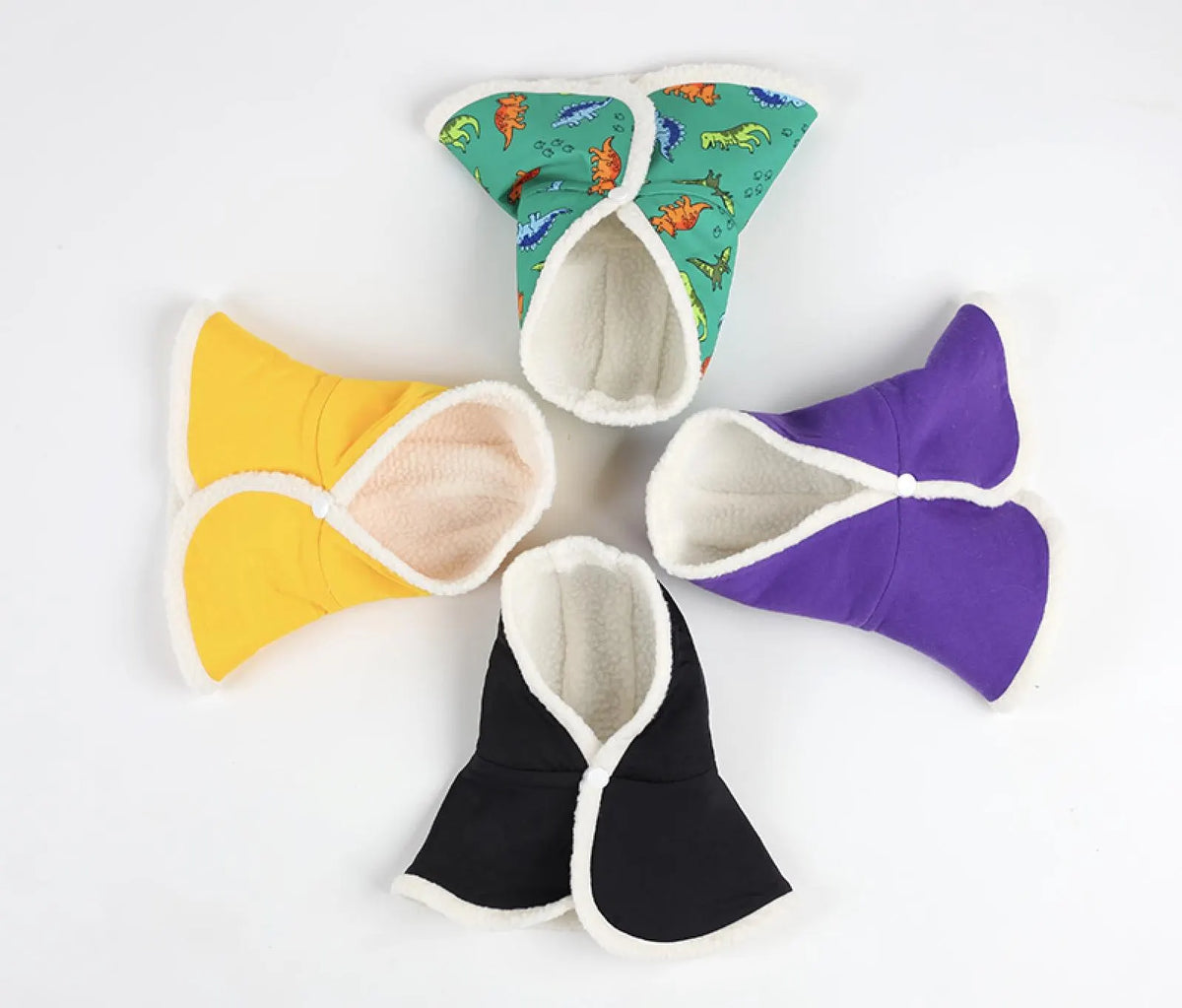 NKpup reversible hoodie capes for dogs in yellow, purple, black, and green dinosaur print.