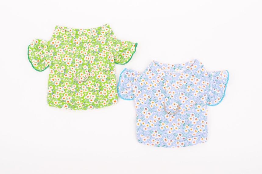 Two floral D-ring dog crop shirts in green and light blue with white daisy patterns.