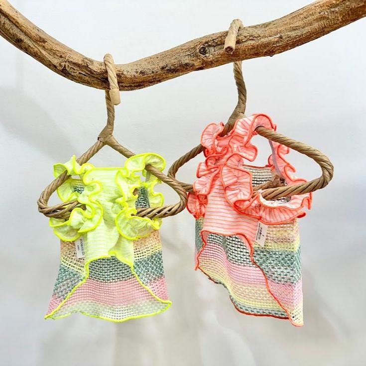 Two NKpup rainbow ruffle mesh dog shirts in neon yellow and coral pink.