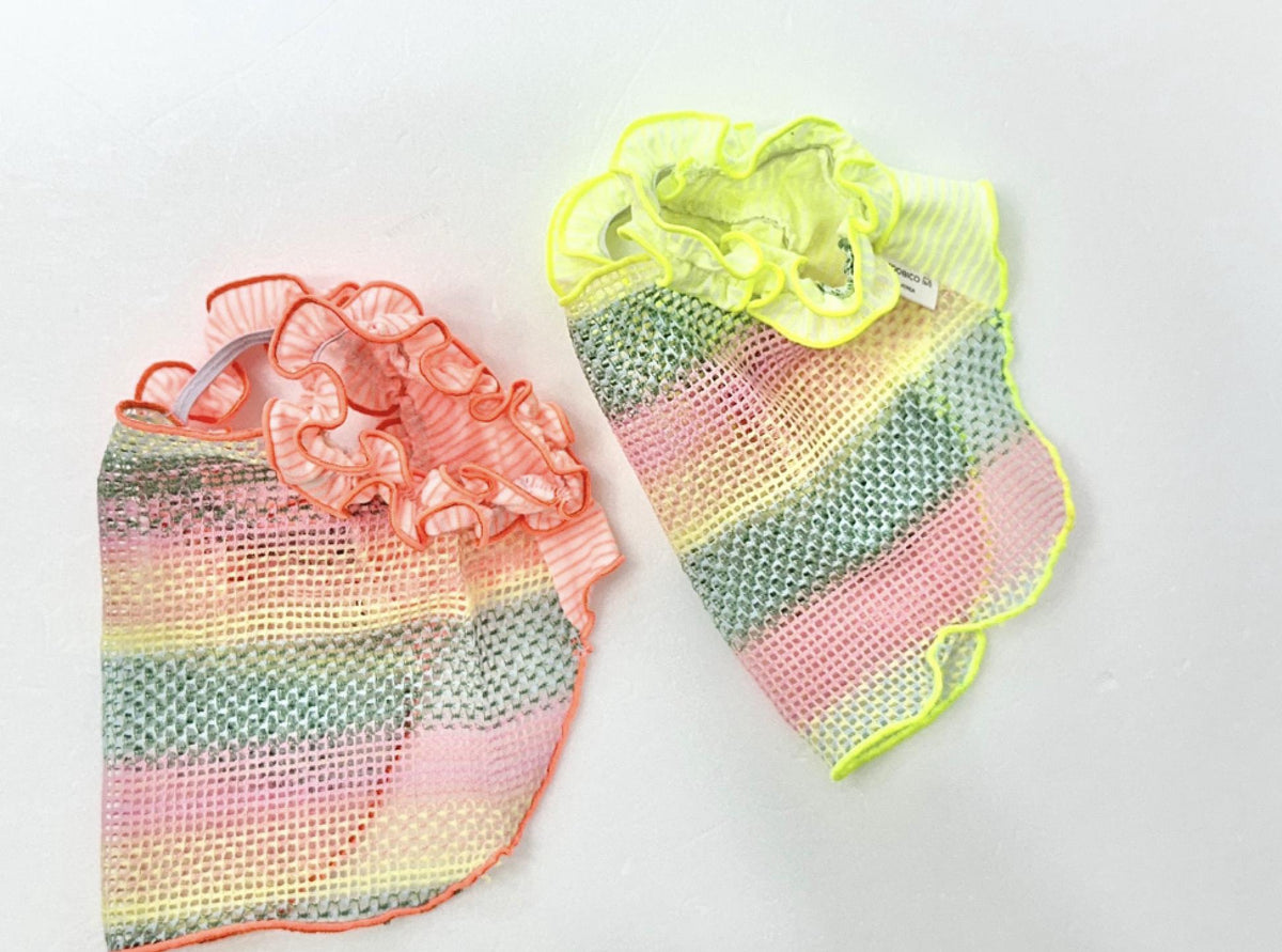 Two rainbow ruffle mesh dog tops in pink and yellow colors.