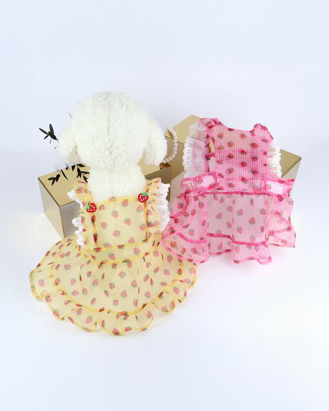 NKpup Strawberry Picnic Dress in yellow and pink with strawberry patterns and ruffle trim.