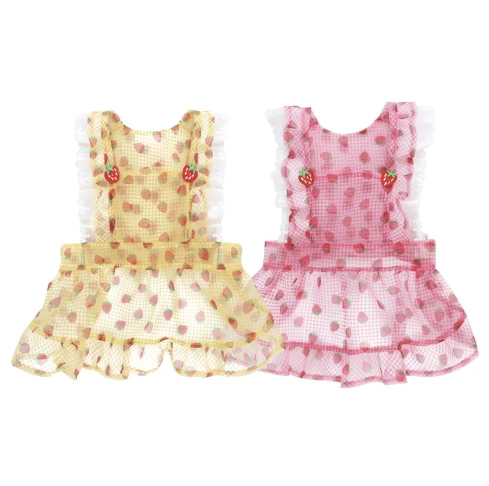 NKpup Strawberry Picnic dog dresses in yellow and pink gingham with strawberry patterns and ruffle trim.