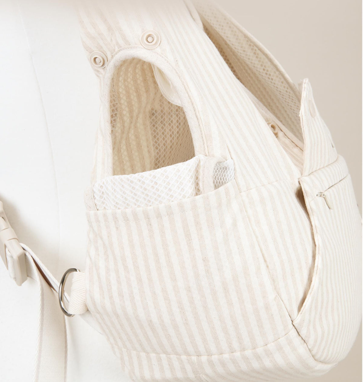 Close-up of a cream striped NKpup pet front carrier featuring mesh lining and adjustable straps.