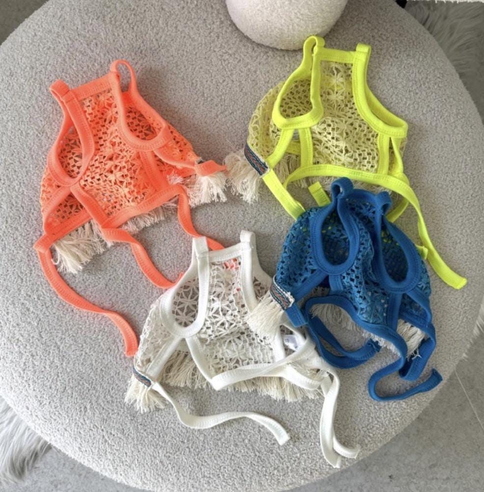 Four Daisy Crochet Dog Tank Tops in orange, lime, blue, and white with fringe details.