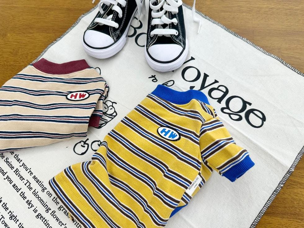 Two HW stripe dog shirts, one beige and one yellow with blue trim.