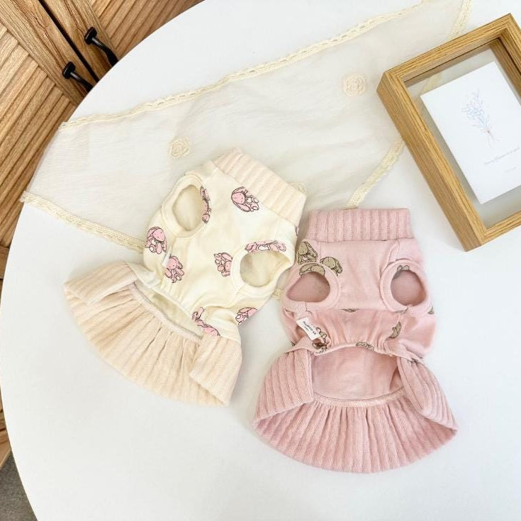 Two NKpup bunny print pet dresses in cream and pink corduroy fabric.