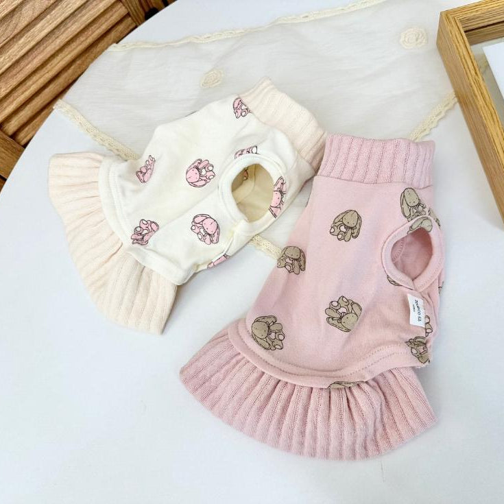 Two NKpup bunny print pet dresses in cream and pink colors.