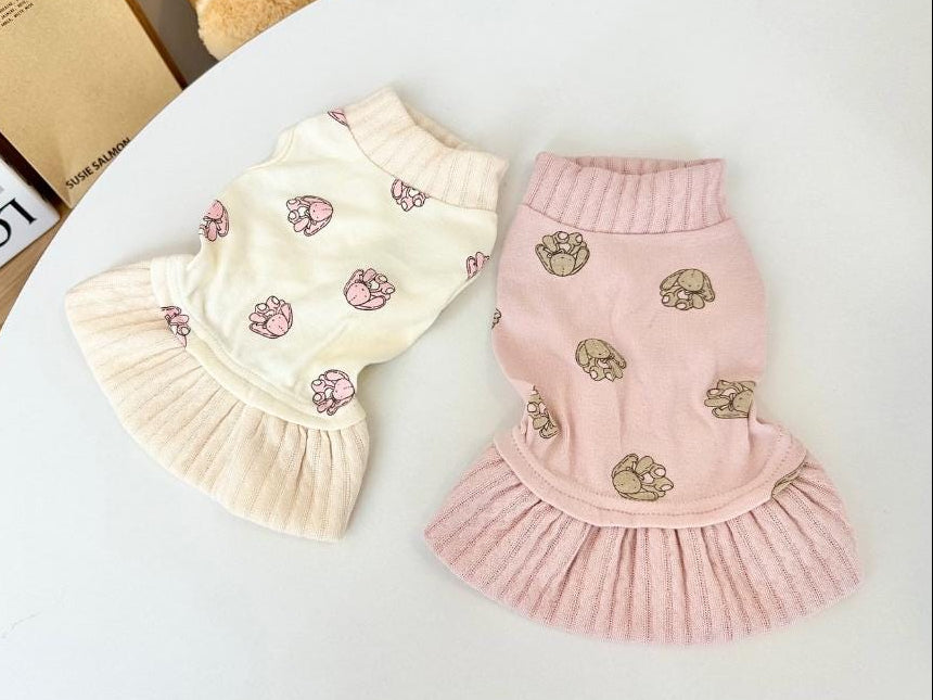 NKpup Bunny Dress pet clothing in cream and pink with paw print patterns and ruffled skirts.