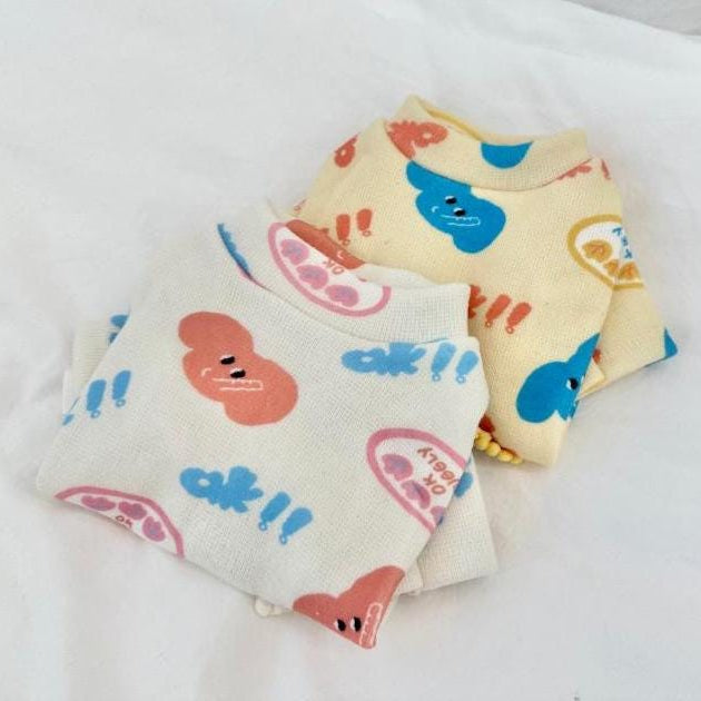 NKpup Snuggly Print Overall pet rompers in white and cream with colorful character patterns