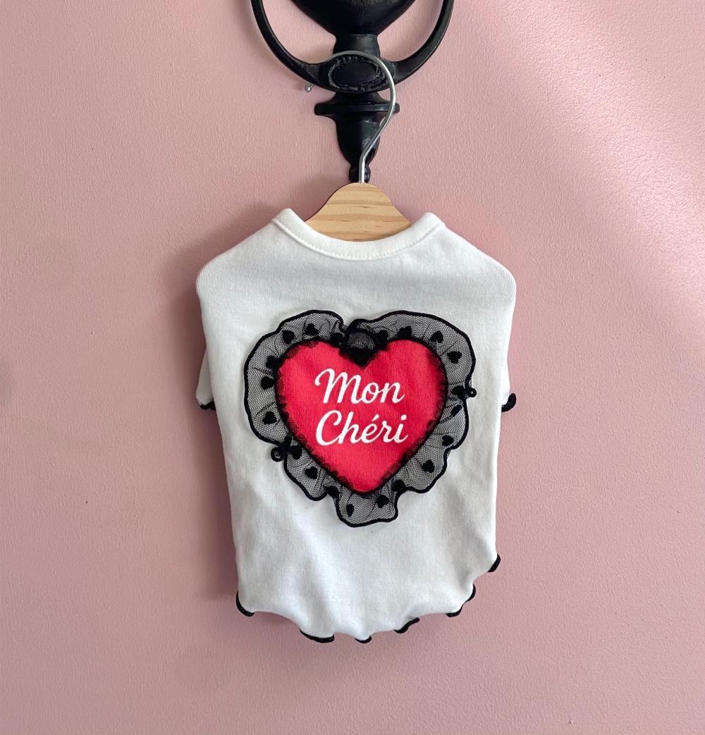 NKpup Mon Cheri white dog shirt featuring a red heart with black lace trim and French text