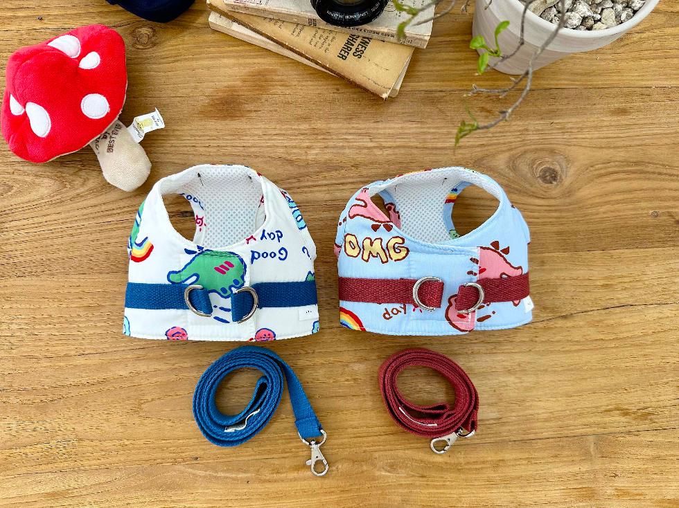 Cartoon print harness and matching leash set in white and light blue with colorful illustrations.