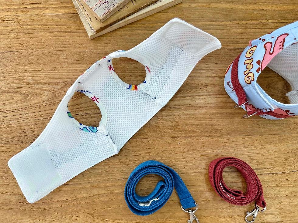 NKpup cartoon print dog harness and matching leash set in white with colorful graphics.