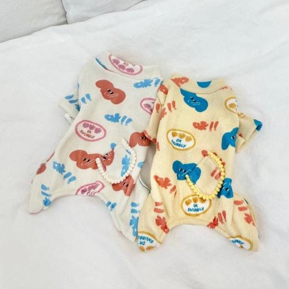 NKpup Snuggly Print Overall dog rompers in white and cream with colorful character patterns.
