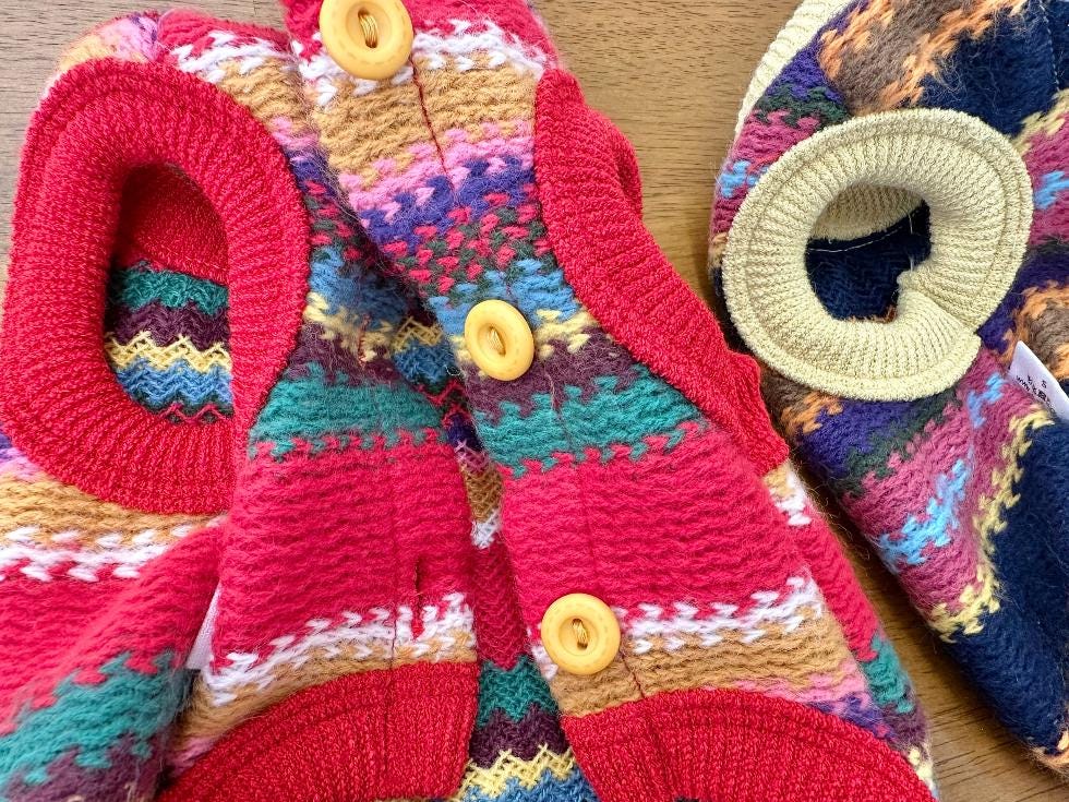 Close-up of the NKpup Bene Zigzag Knit Dog Vest in red with multi-colored stripes and brown buttons.