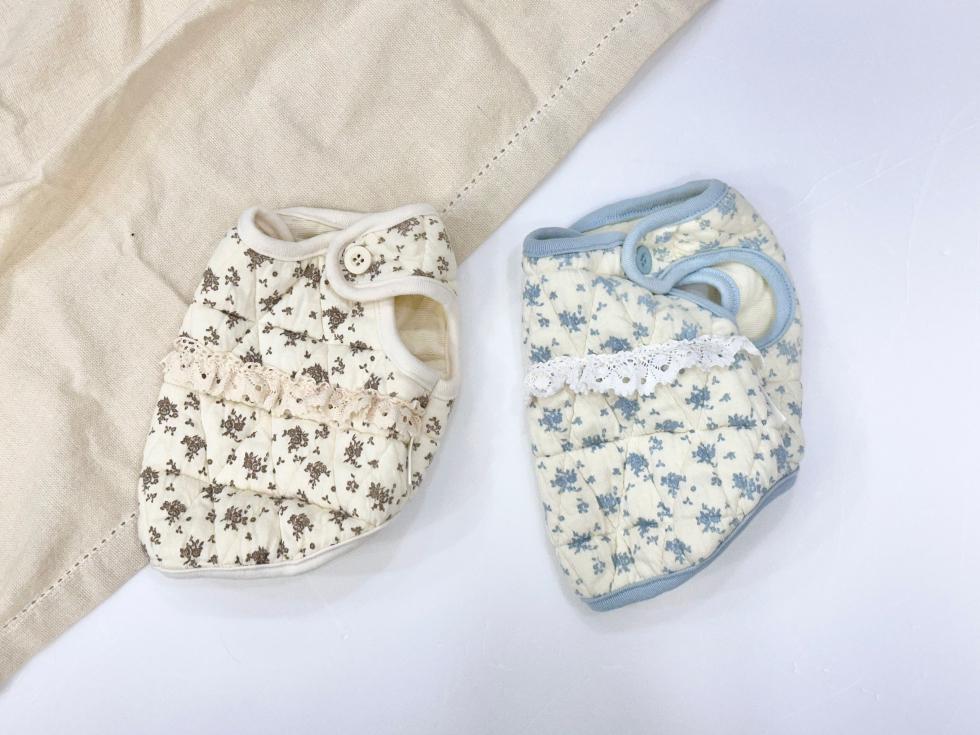 Cozy floral dog vests in cream with brown and blue flower patterns and lace trim.