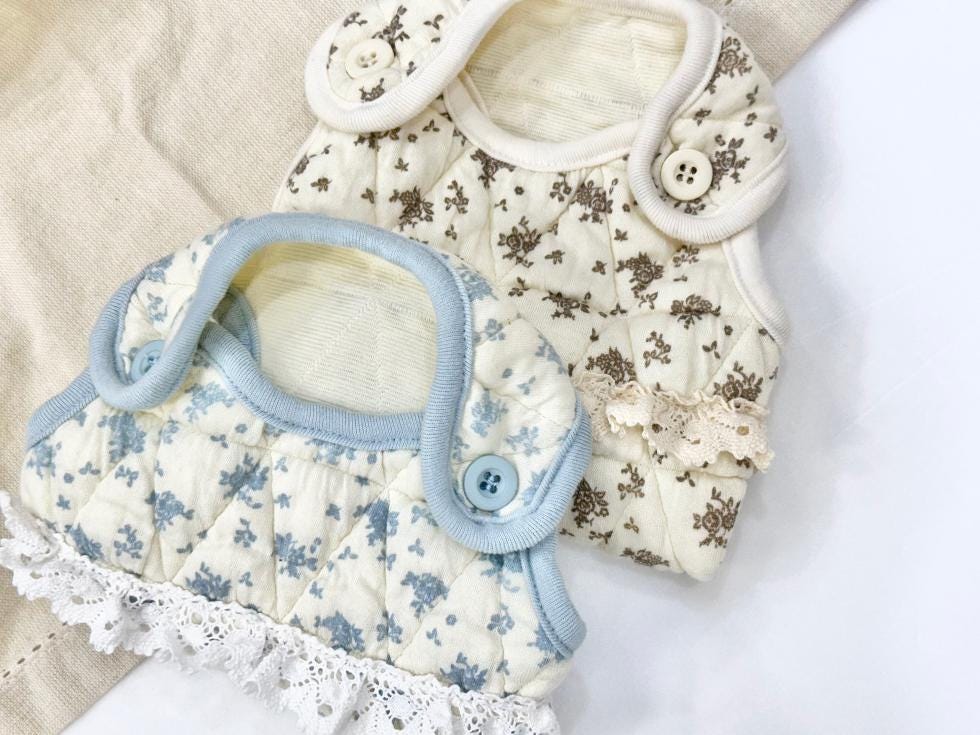 NKpup cozy floral dog vest and overall set in light blue and cream patterns with lace trim.