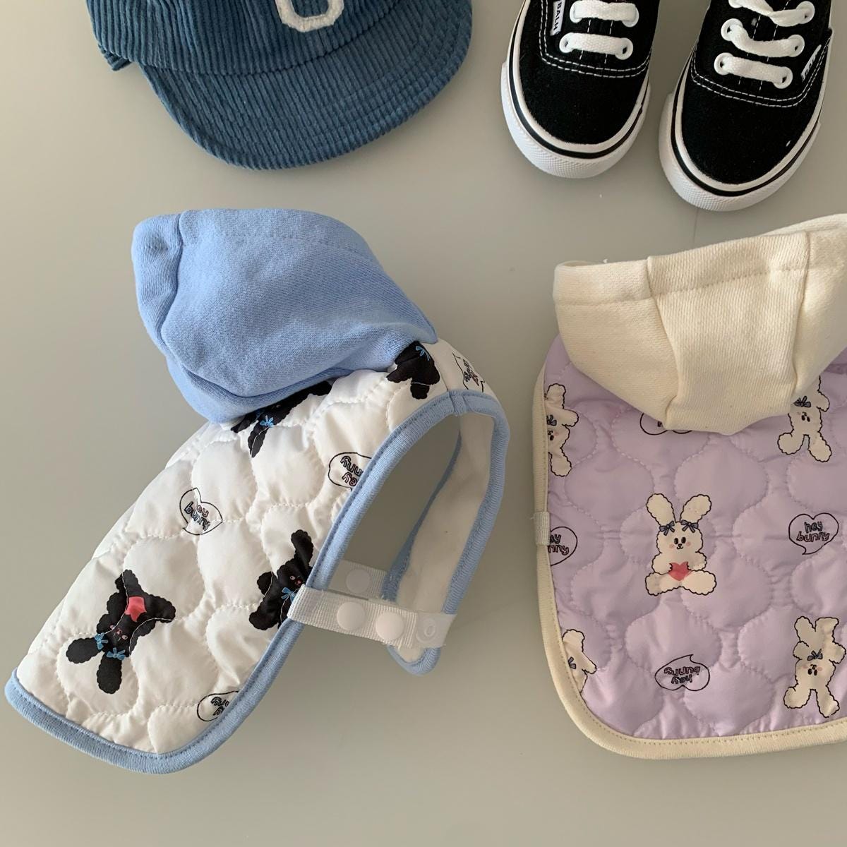 White quilted dog vest with black bear pattern and light blue hood by NKpup