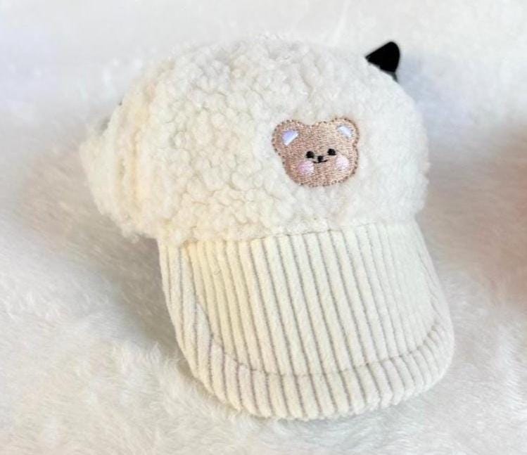 White teddy fleece cap with a small bear embroidery and corduroy brim