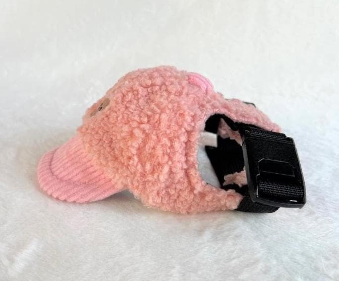 NKpup pink teddy fleece cap with a corduroy brim and black buckle strap